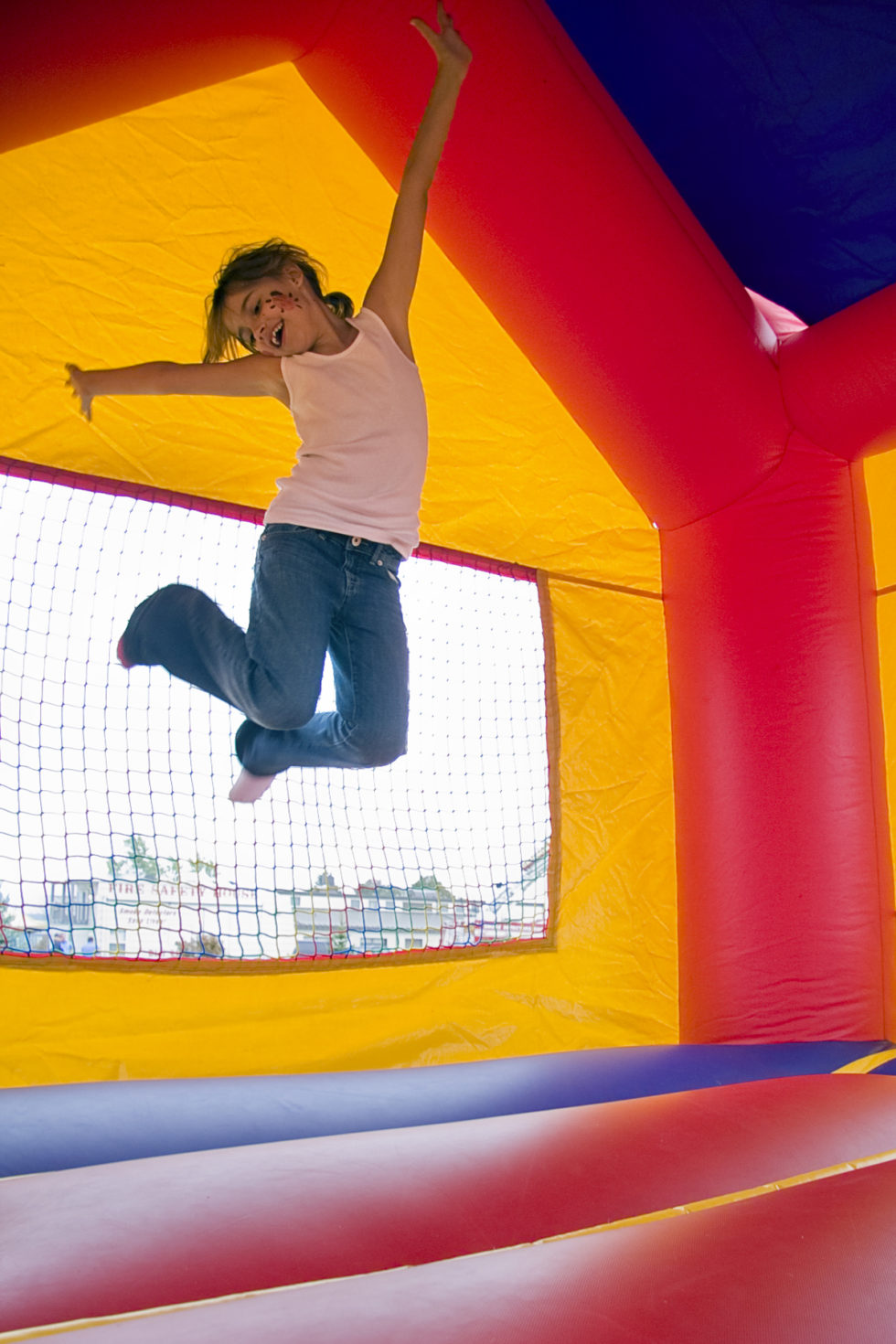 kid playing on bouncy castle